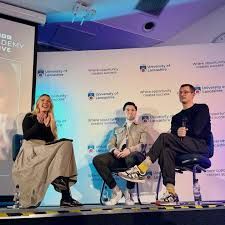 Image of three people talking in panel Image of three people talking in panel