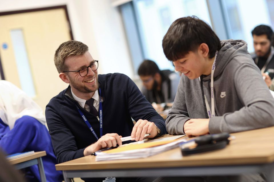 Staff smiling and delivering a lesson