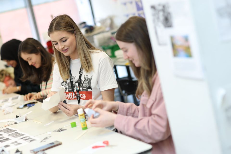 Image of two students creating artwork