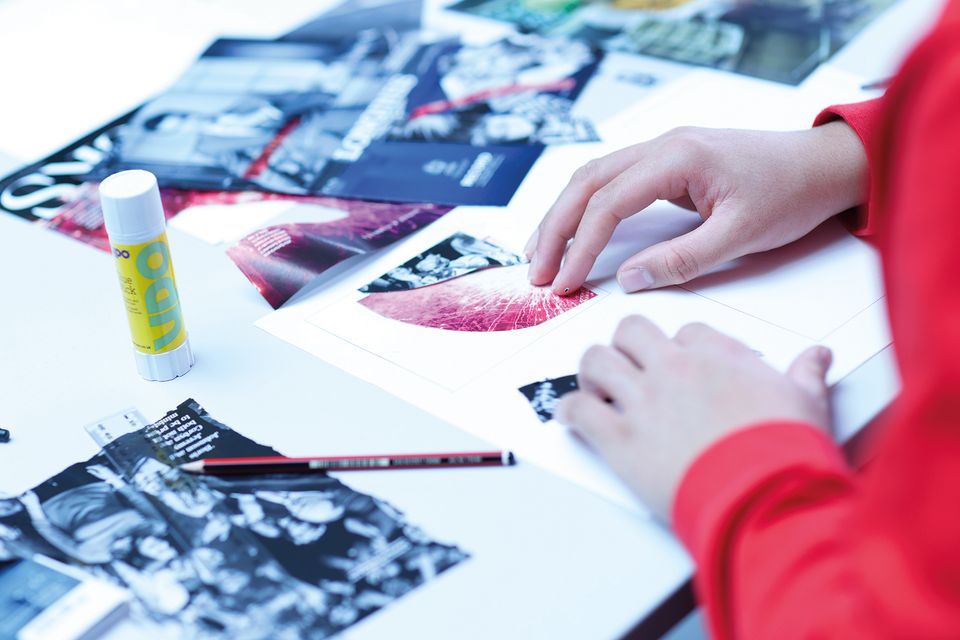 Image of two hands creating artwork