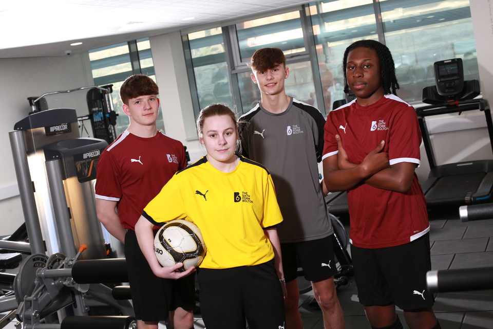 Image of four students in college sports kits